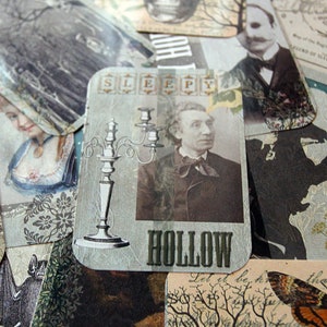 May include: A vintage style card with a candelabra and the words "Sleepy Hollow" printed on it. The card is decorated with a floral pattern and has a distressed look.