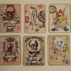 May include: Six tarot cards with a vintage aesthetic. The cards feature illustrations of a skull, a goat, a globe, a woman with wings, a skull with a crown, and a moon with a face. The cards are labeled "The Devil", "The World", "Temperance", "Death", "The High Priestess", and "The Moon".