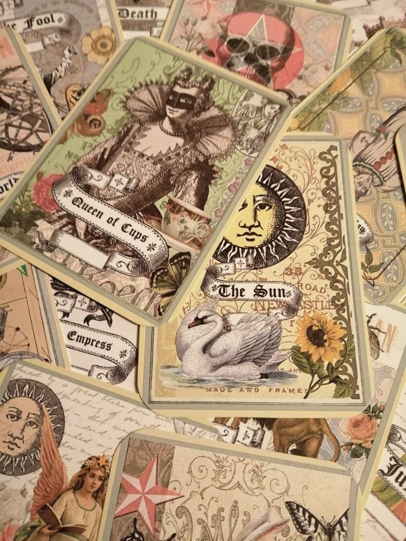 May include: A collection of tarot cards with various designs, including a Queen of Cups, The Sun, and The Empress. The cards are decorated with intricate details and imagery.