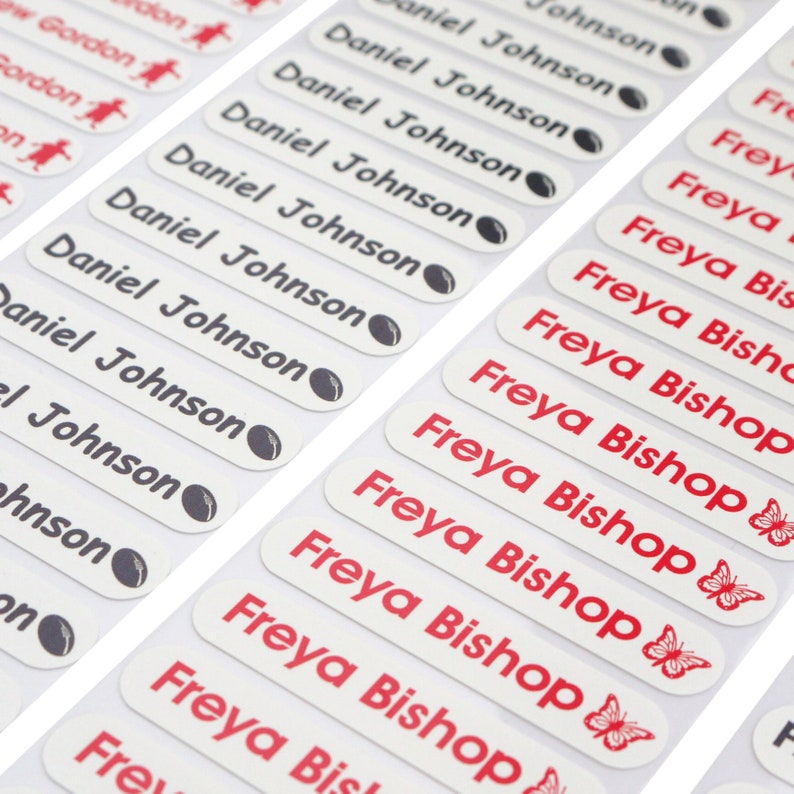 May include: A sheet of white labels with black and red text. The labels are for personalizing items with names. The labels read "Daniel Johnson" and "Freya Bishop".