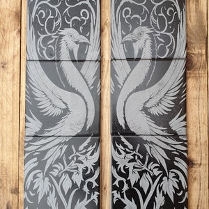 May include: A set of six black and silver ceramic tiles with a repeating pattern of stylised birds and floral designs.