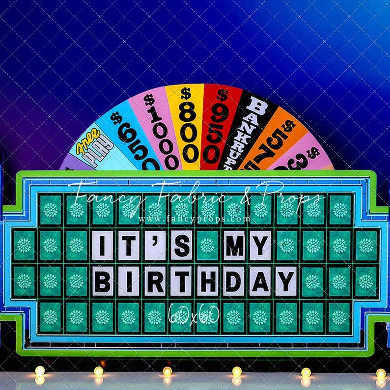 May include: A green and white game show wheel with the phrase "It's My Birthday" on the front. The wheel has a colorful spinning wheel with dollar amounts and the words "Bankrupt" and "Free Play" on it.