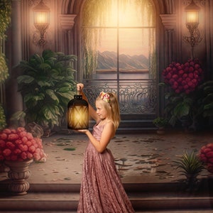 May include: A young girl in a pink dress holds a lantern in a room with a large window and ornate details. The room is decorated with plants and flowers.