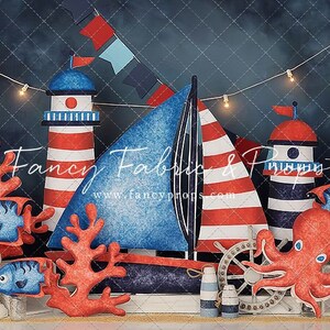 May include: A nautical themed backdrop featuring a blue and red sailboat, two red and white striped lighthouses, a red octopus, two blue fish, and coral. The backdrop also includes a white wooden plank, a white seashell, and a blue and white sailor hat.