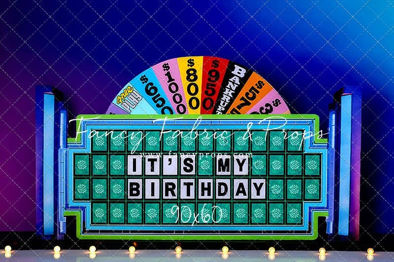 May include: A blue and green game show backdrop with a wheel of fortune and a large game board that says "It's My Birthday".