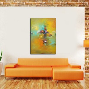 May include: Abstract painting with a yellow, green and blue colour scheme. The painting features a central cluster of colourful shapes and a reflection in the water below.