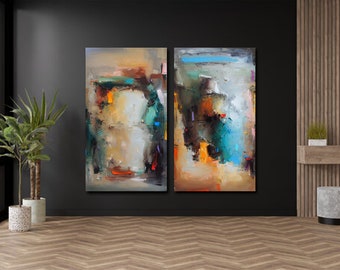 May include: Two abstract paintings with a textured, colorful design. The artwork features a mix of colors, including orange, blue, and green, against a neutral background. The paintings are displayed on a dark wall in a room with wooden flooring.