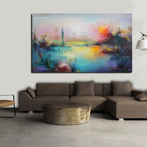 May include: Abstract landscape painting with a colorful palette of blues, greens, yellows, and reds. The painting depicts a lake with a distant cityscape and a sunset sky.