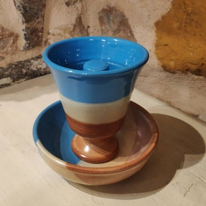 Set of a Handmade Pythagoras cup with a pottery bowl of the same color.