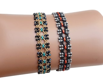 May include: Two beaded bracelets, one with black, gold, and teal beads, and the other with black, gray, and orange beads.