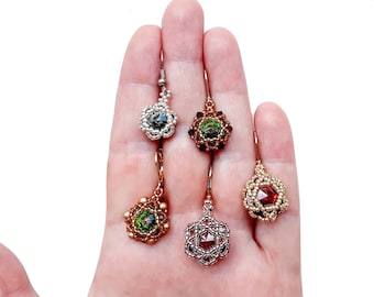 May include: Four pairs of beaded earrings with different colored stones. The earrings are silver, gold, and copper with green and red stones.