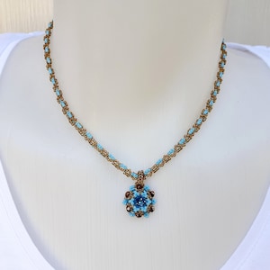 May include: A delicate necklace with a blue and brown beaded chain and a blue and brown beaded pendant.