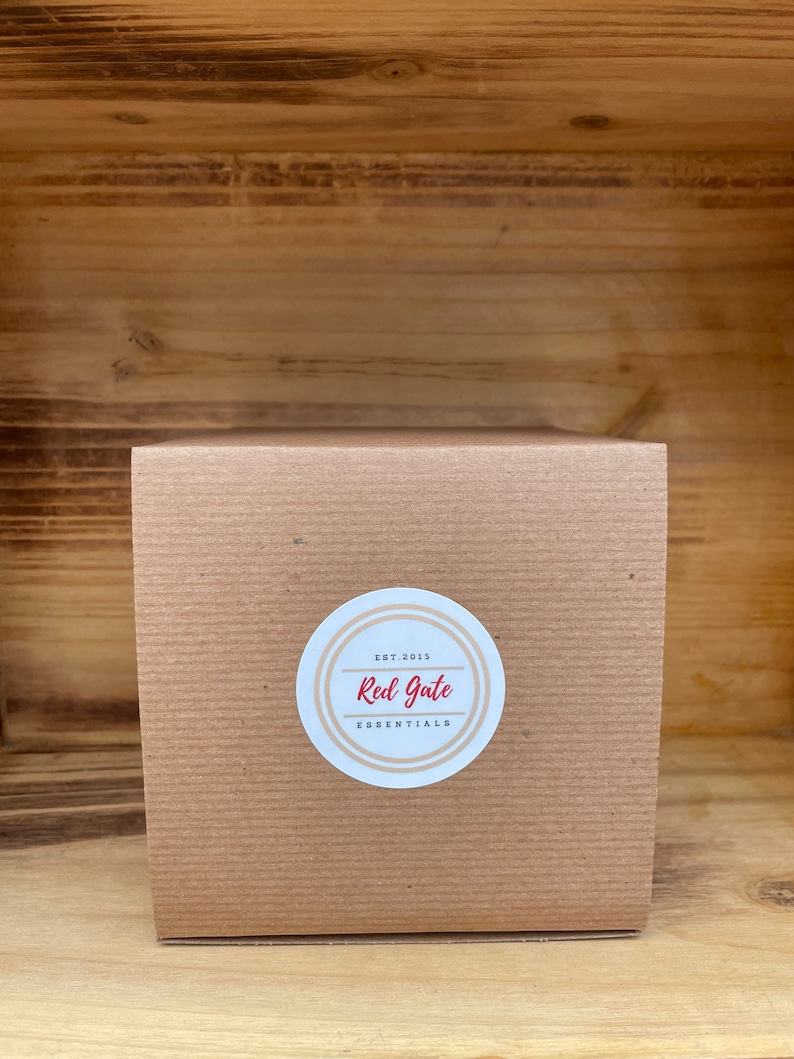 May include: A brown cardboard box with a white circle sticker that says "Est. 2015 Red Gate Essentials".