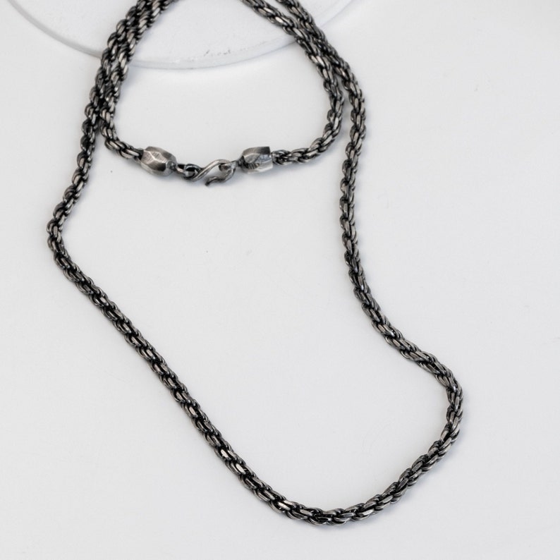 Oxidized rope chain necklace with hand carved end caps and hook at closure