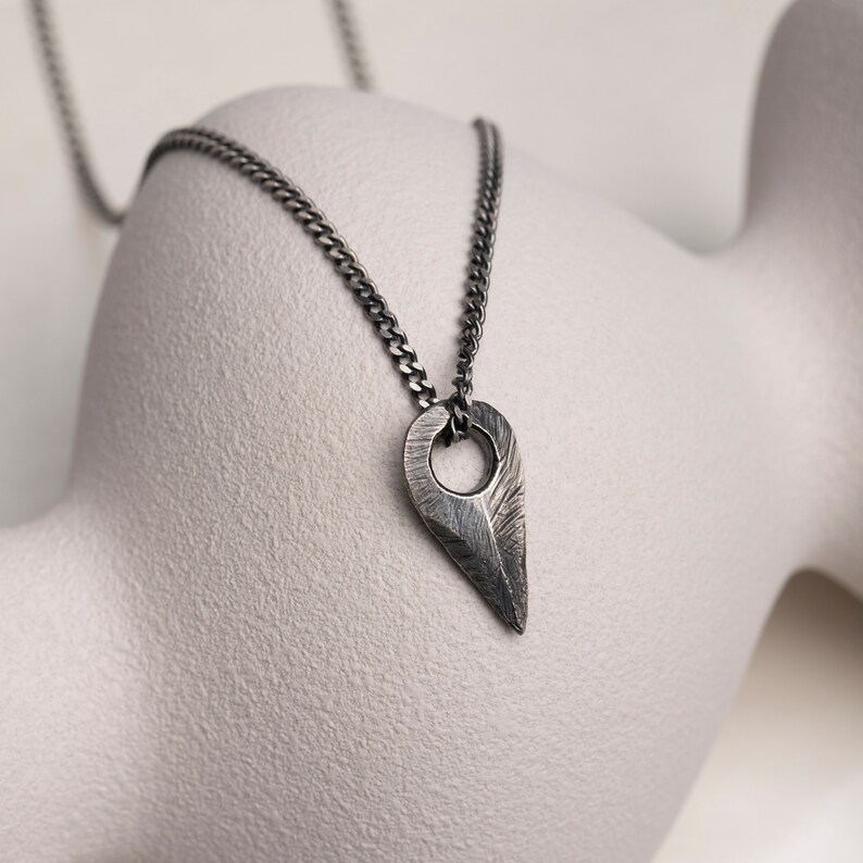 Unisex sterling silver arrow pendant necklace, crafted in brutalist fashion with an oxidized silver finish, ideal for both genders.