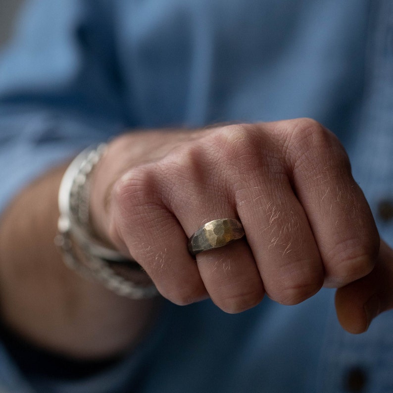 Wide band ring for men in brutalist style. The band is made of sterling silver that is oxidized and the top of 14K solid yellow gold.