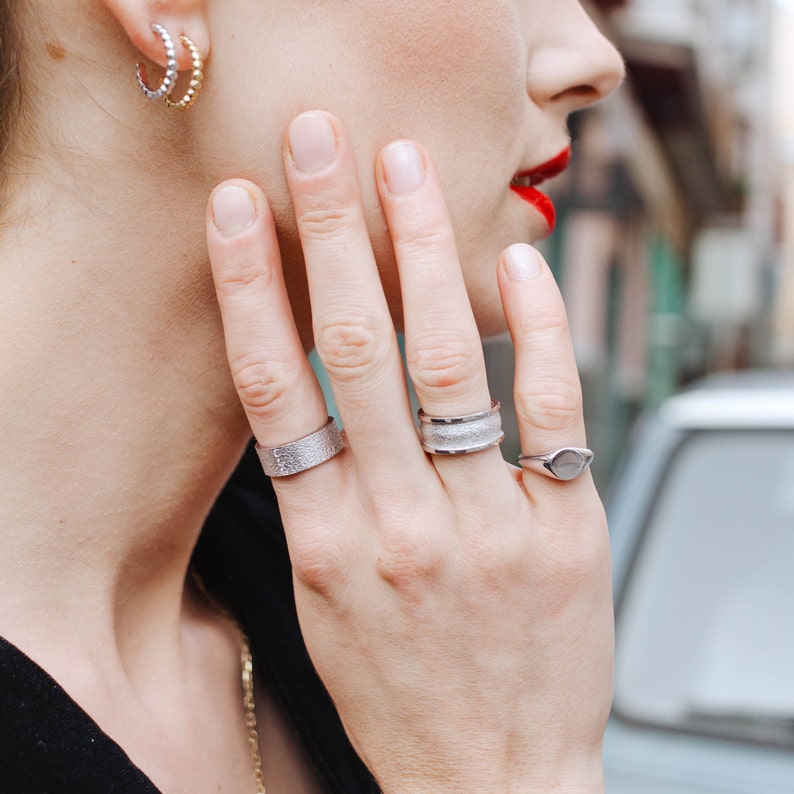 Combination of silver rings on woman's hand