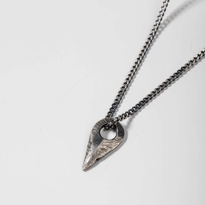 Handmade sterling silver arrow pendant necklace in brutalist style, oxidized for a distinctive look, perfect for both genders.