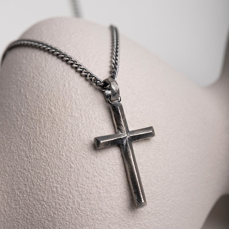 Oxidized silver cross necklace for men and women in brutalist style.