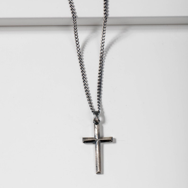 Oxidized silver cross necklace for men and women in brutalist style.