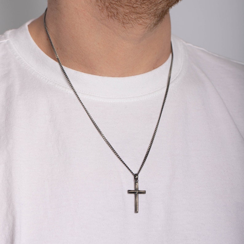 Men's cross necklace in rustic design. The necklace is made of oxidized sterling silver 925.