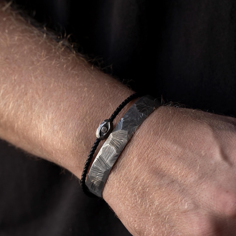 Sophisticated black leather bracelet for men, accented with an oxidized sterling silver evil eye charm in a bold brutalist design