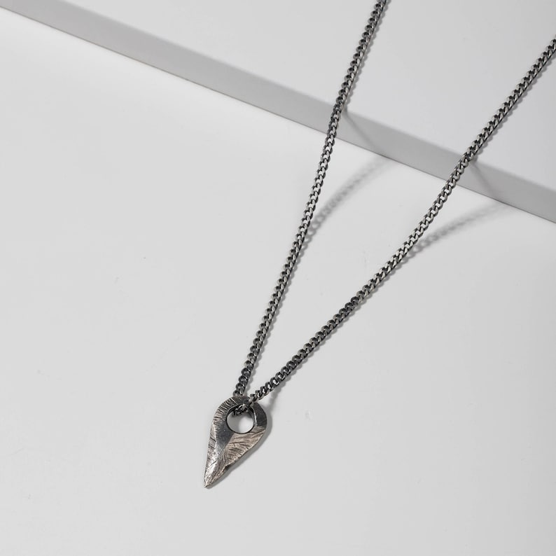 Handcrafted brutalist sterling silver arrow necklace, featuring an oxidized finish, designed for men and women.