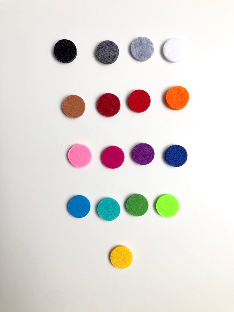 May include: Assortment of felt circles in various colours, including black, grey, white, brown, red, orange, pink, purple, blue, green, yellow, and lime green.