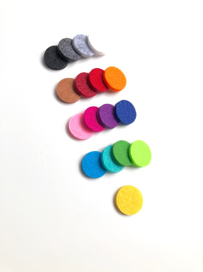 May include: A set of 14 round felt diffusers in various colours, including grey, white, brown, red, orange, pink, purple, blue, green, and yellow. The diffusers are arranged in a staggered pattern on a white background.