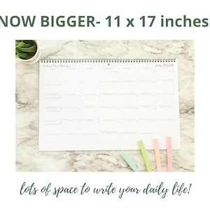 May include: A white 2026 calendar, measuring 11 x 17 inches, with a spiral binding. The calendar has large boxes for each day and includes the text "lots of space to write your daily life!" and "NOW BIGGER-".