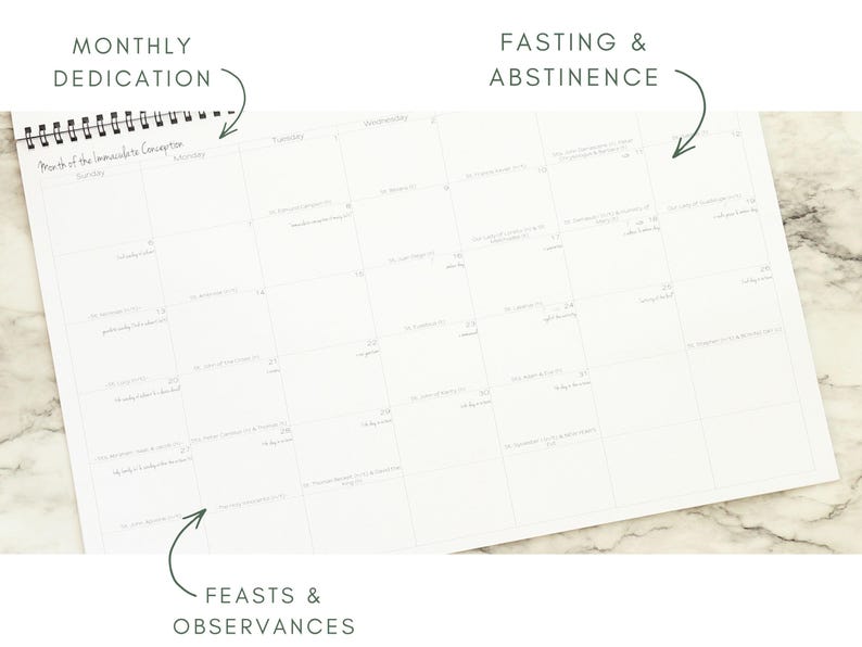 May include: A white spiral-bound calendar with a grid layout. The calendar is open to a month with handwritten entries. Text at the top reads "Monthly Dedication" and "Fasting & Abstinence." The bottom reads "Feasts & Observances."