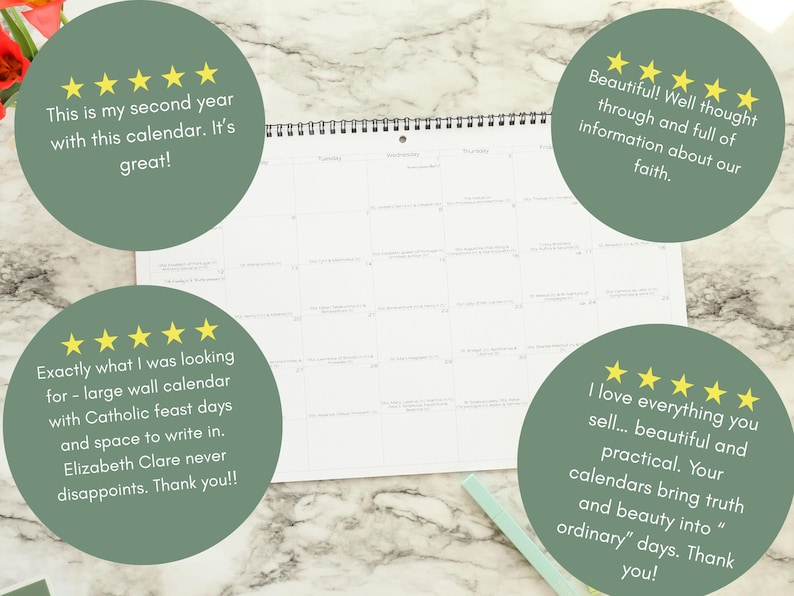 May include: A white wall calendar with a spiral binding, open to a blank month view. The calendar is on a marble surface, with green circles containing customer reviews and gold stars. A light green pen rests nearby.