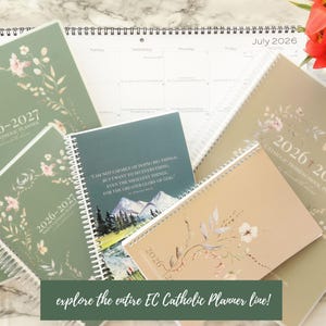 May include: An assortment of 2026-2027 Catholic planners and a calendar, in various sizes and colors, with floral designs. The planners are in shades of green and beige, with spiral binding. The text "explore the entire EC Catholic Planner line!" is visible.