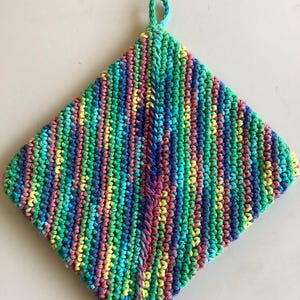 May include: A colorful, handmade crochet potholder. The square potholder features vertical stripes of various colors, including green, blue, yellow, and pink. A small loop is attached at the top for hanging. This kitchen accessory is perfect for protecting hands from hot cookware.
