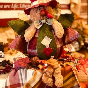 Thanksgiving turkey sitting plush soft feathers, a cute face, and a comfortably seated posture