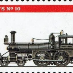 Puede incluir: Una locomotora de vapor negra vintage con ruedas rojas, etiquetada "ELY'S No 10" y "USA 29", en un sello postal rojo y blanco.