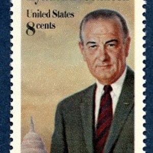 May include: A vintage United States postage stamp featuring a portrait of Lyndon B. Johnson, the 36th President of the United States. The stamp is 8 cents and features a depiction of the US Capitol building in the background.