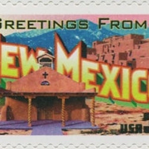 May include: A vintage-style postcard with the text "Greetings from New Mexico" in a yellow and orange font. The postcard features a small adobe church with a cross on the roof and a mountain range in the background.