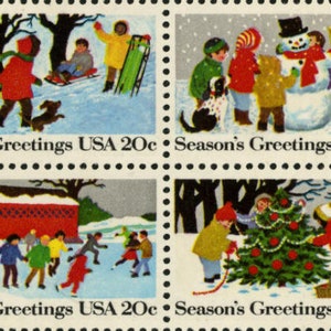 May include: Four vintage Christmas stamps featuring winter scenes. Each stamp has a red and white border with the text "Season's Greetings USA 20c". The first stamp shows children sledding in a snowy forest. The second stamp shows children building a snowman. The third stamp shows children playing in the snow near a red covered bridge. The fourth stamp shows children decorating a Christmas tree.
