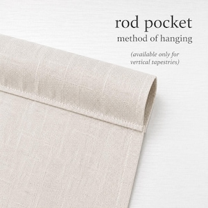 a close-up view of a beige fabric, possibly a piece of clothing or a textile, with a folded or rolled end. The text above the image reads "rod pocket method of hanging" and below it, "(available only for vertical tapestries)"