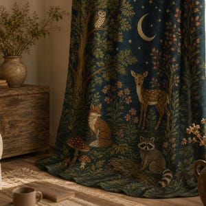 May include: A dark blue curtain featuring a forest scene with a deer, a fox, a raccoon, and an owl. The fabric displays a crescent moon, stars, trees, flowers, and mushrooms in shades of green, brown, and gold, creating a detailed woodland pattern.