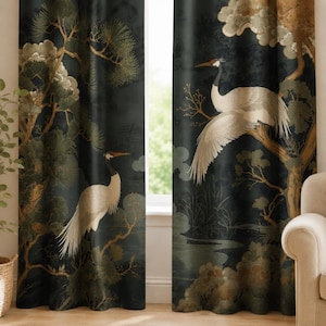 May include: A pair of floor-length curtains featuring a dark background with a printed pattern of white cranes, pine trees, and muted green foliage. The design depicts birds in flight and standing positions amidst branches and landscape elements.
