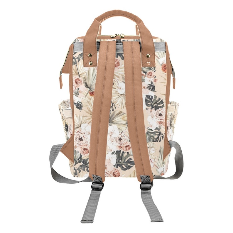 May include: A beige and brown floral print backpack with adjustable straps. The backpack has a zipper closure and two side pockets.