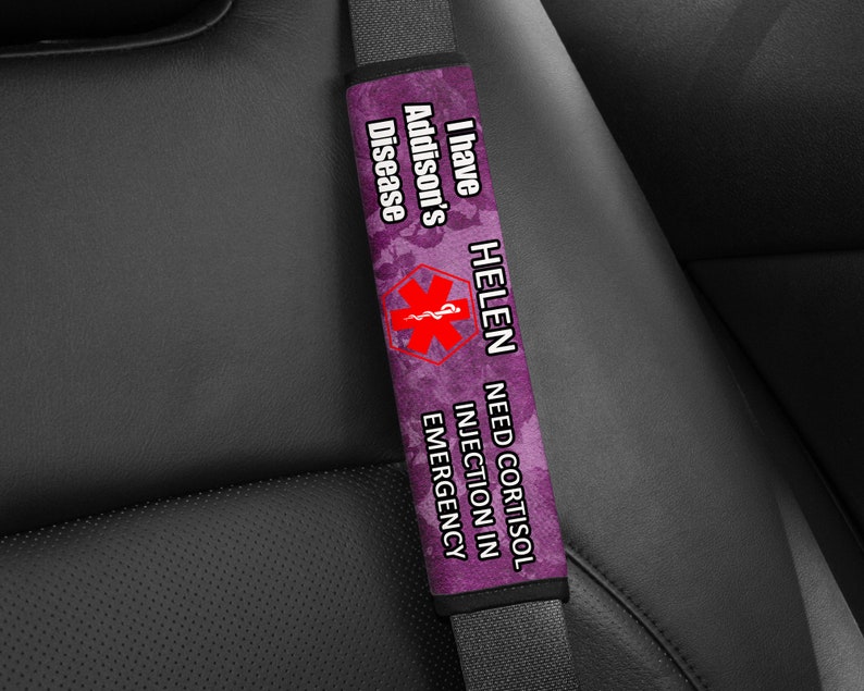 May include: Purple and black car seatbelt safety strap with the text "I have Addison's Disease HELEN NEED CORTISOL INJECTION IN EMERGENCY" and a red medical symbol.