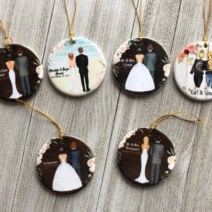 May include: Six round ceramic ornaments with gold string hangers. Each ornament features a different couple with a personalized name and date. The ornaments are decorated with floral designs and a woodgrain background.