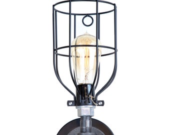 May include: Black metal cage light fixture with a clear glass bulb and a black pipe base. The base has a round, flat plate with a screw.
