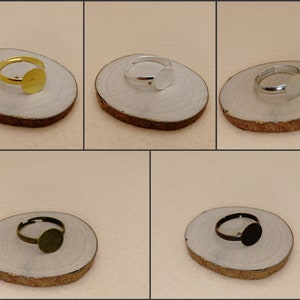 May include: Four adjustable ring blanks with round bezels in gold, silver, bronze, and black.
