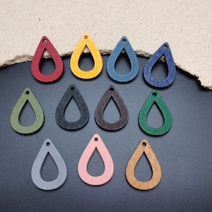 May include: Twelve wooden teardrop-shaped earring blanks in various colors, including red, yellow, blue, green, black, brown, gray, and pink.