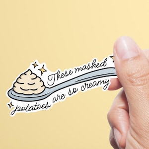 May include: A sticker showing a cartoon image of mashed potatoes on a spoon. The text reads "These mashed potatoes are so creamy" in a handwritten font, with star accents.