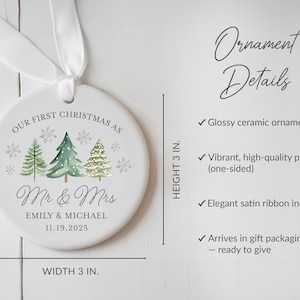 May include: A white ceramic Christmas ornament, 3 inches in diameter, with a watercolor design of three Christmas trees and snowflakes. The text reads "Our First Christmas as Mr & Mrs" with a couple's names and date. Includes a white satin ribbon.